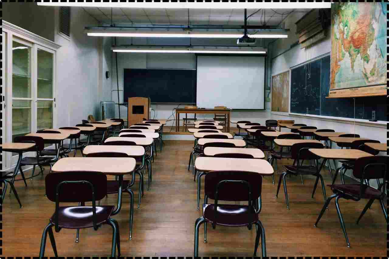 Spacious classroom with desks and chairs arranged neatly.